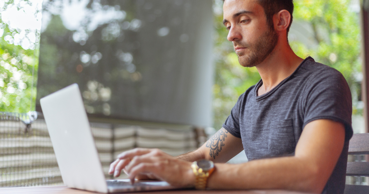 Man writing using laptop