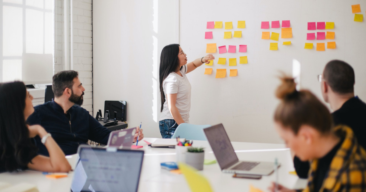 Woman picking sticky note