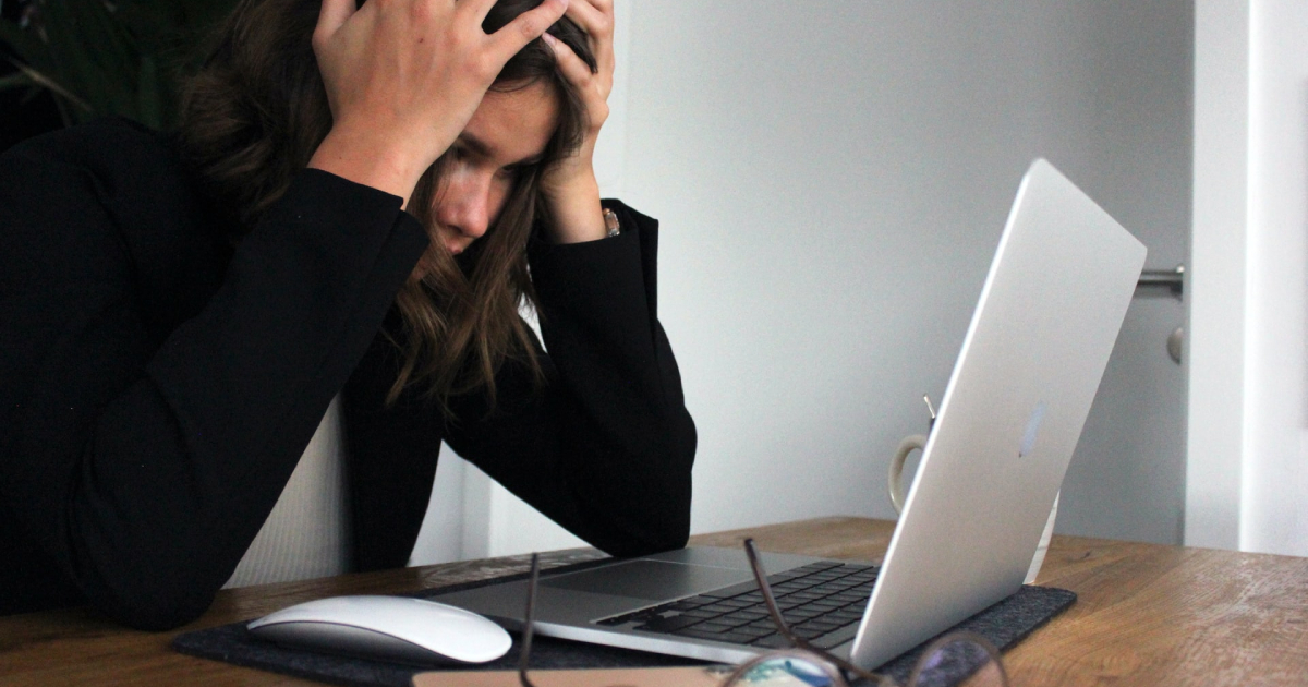 Frustrated woman looking at laptop