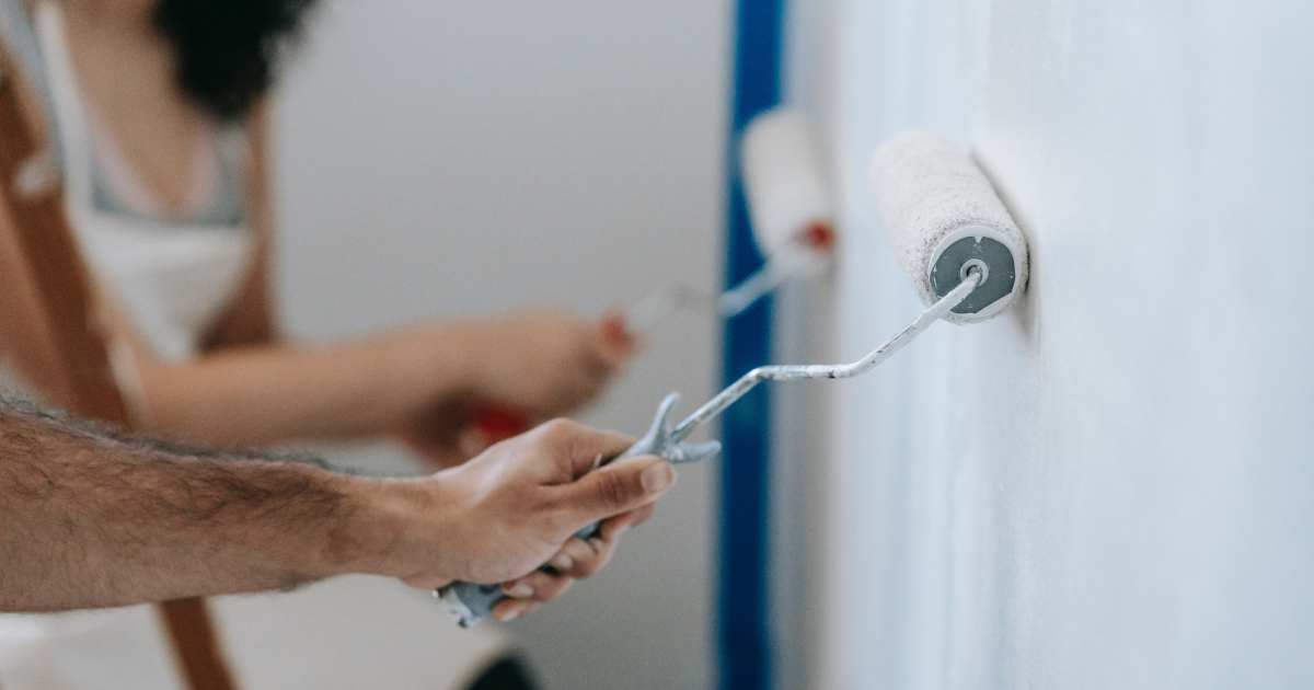 Person painting a wall