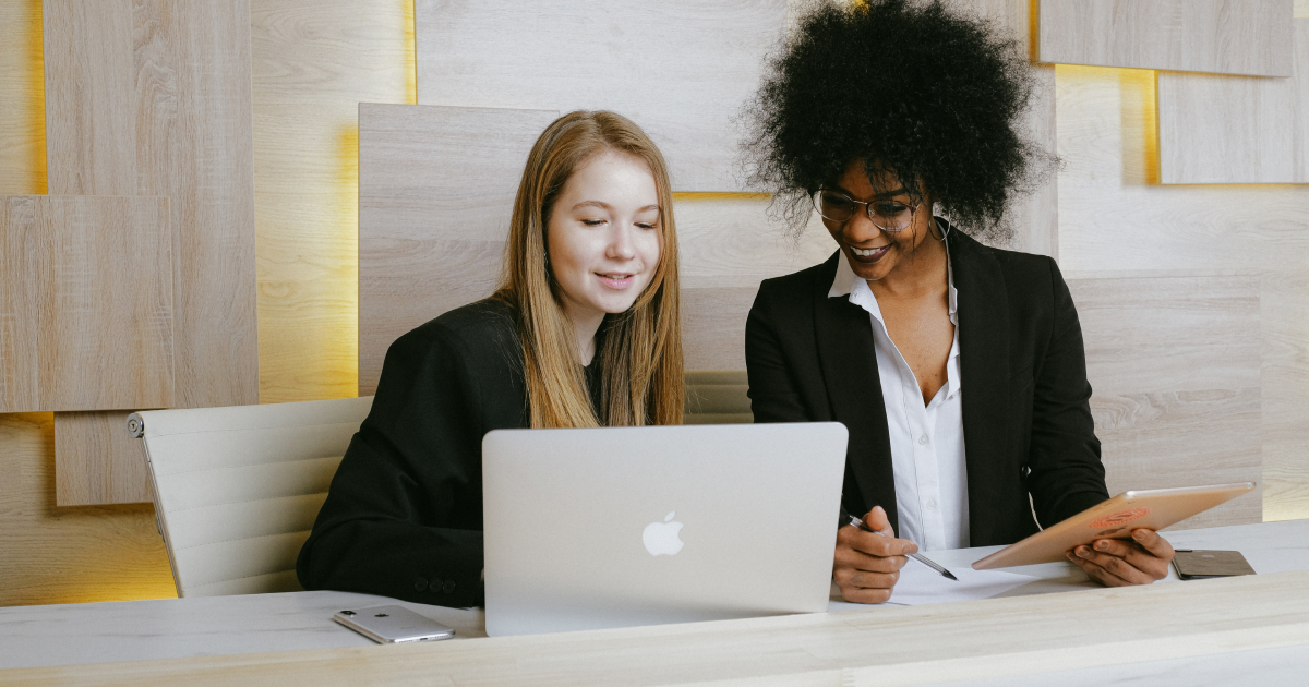 Two women working on laptop