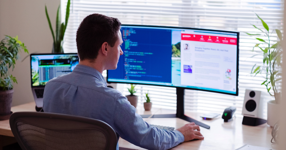 Man in front of monitors