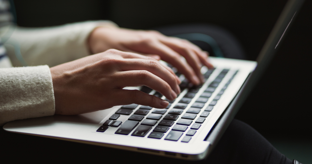 Hands typing on keyboard