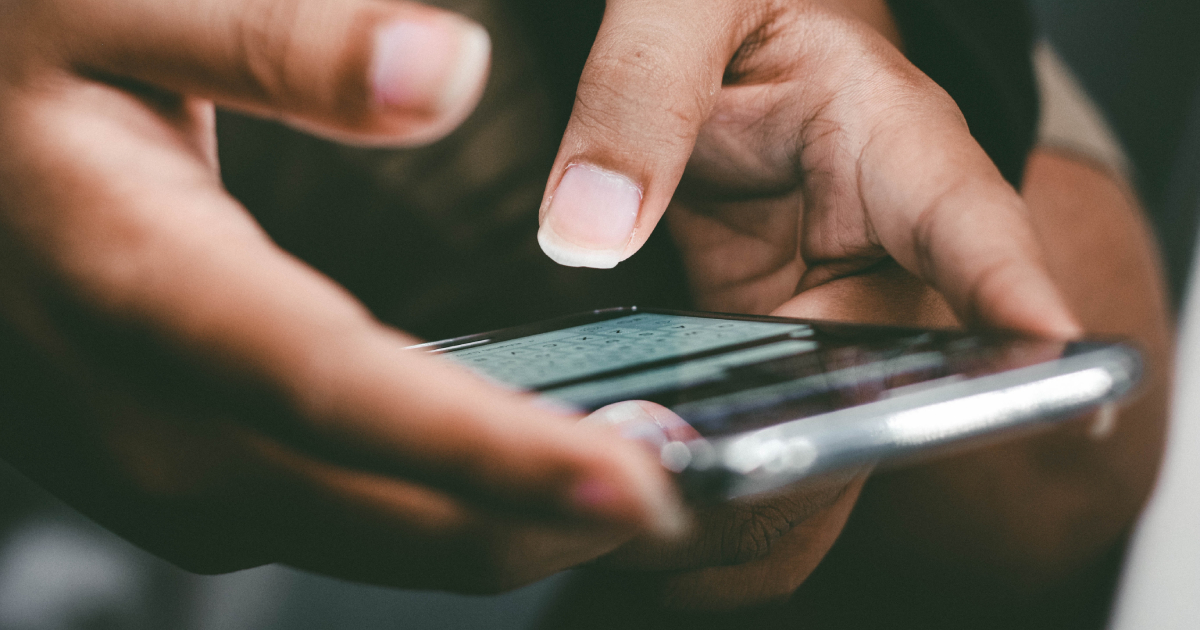 Hands holding phone